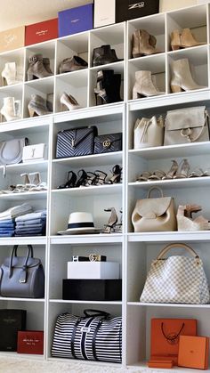 a white shelf filled with lots of purses and handbags