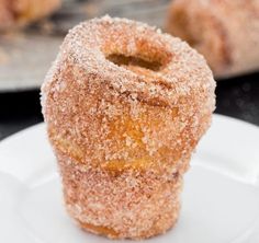 two donuts sitting on top of a white plate