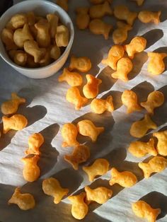 some small pieces of food next to a bowl