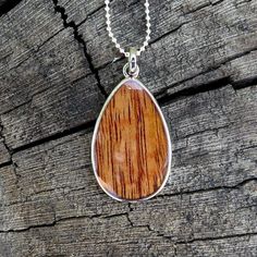 "Pendant size: 41mm x 24mm Thickness: 3mm Metal: Rhodium Plated on Brass Material: Genuine Hawaiian Koa Wood 18\" Silver-Colored Box Chain Included" Red Necklace With Polished Finish As Gift, Red Necklace With Polished Finish For Gift, Nickel-free Brown Necklace For Gift, Polished Teardrop Pendant Necklace For Gift, Teardrop Pendant Necklace With Polished Finish For Gifts, Brown Pendant Jewelry With Lobster Clasp, Brown Teardrop Jewelry For Gift, Brown Necklaces With Lobster Clasp As Gift, Brown Necklace With Lobster Clasp As Gift