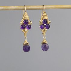 "Amethyst Jewelry, Gemstone Jewelry, Amethyst Third Eye Earrings, Gold Filled Jewelry, Meditation Jewelry, Handmade Amethyst Jewelry Cosmic third eye earrings are made of natural purple amethyst gemstones set on silver bezel and hand twisted gold filled wire around it. Gold filled beads are interwoven gently, and a beautiful faceted amethyst drop dangles down. The hook is made of gold filled. The \"third eye\" is referred as the intuitive spiritual eye, or the eye of the soul. It is associated w Purple Amethyst Gemstones With Accents, Purple Amethyst Earrings With Gemstone Accents, Lavender Amethyst Earrings With Gemstone Accents, Purple Amethyst Teardrop Gemstone, Purple Amethyst Birthstone Earrings, Purple Teardrop Amethyst Gemstone, Handmade Amethyst Teardrop Gemstones, Handmade Teardrop Amethyst Gemstones, Spiritual Eye