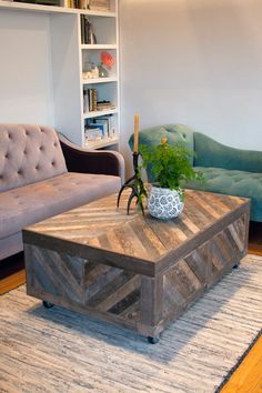 a living room with a couch, coffee table and bookshelf in the background