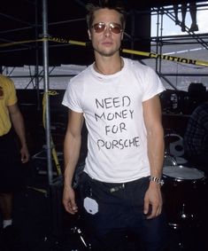 a man with sunglasses and a t - shirt that says need money for pursche