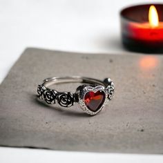 Our adjustable garnet heart rose ring is a intricate statement piece that combines the charm of the Victorian era with a macabre gothic twist. 🖤 🦇  The centerpiece of this romantic Victorian ring is a stunning red garnet heart, symbolizing deep love, passion, and devotion. ♥️ 🥀  This stunning ring is the perfect accessory for anyone who loves gothic, boho, or witchy jewelry. The vintage Victorian vampire design is both elegant and eerie, making this ring a truly unique statement piece. ️ 💍 T Gothic Rings For Valentine's Day Gift, Valentine's Day Gothic Rings As Gift, Vintage Halloween Rings As Gifts, Vampire Design, Vampire Jewelry, Victorian Vampire, Gothic Boho, Garnet Heart, Victorian Ring