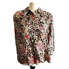 This is a Vintage Studio Works Cheetah Print Floral Button Down Shirt in Sz L Womens. It is a cute animal print Nineties Blouse with orange lily print, a collar, and 3/4 sleeve and pearlescent buttons. It is in excellent condition with no rips, stains, tears, or holes. Appx Measurements: Armpit to Armpit: 25" Bust: 50" Waist: 48" Hips: 50" Shoulder to Hem: 25" Sleeve Length: 13" Material: 100% Linen Size: Womens L Condition: Pre-Owned Good It is in excellent condition with no rips, stains, tears, or holes.  At MayFlower Market we unlock treasures from the past & hunt for Antiques, Unique Vintage Items, Oddities, Treasures, & Designer Names to enhance your home and collection. We add new pieces each week. So be sure to keep checking our stores. Long Sleeve Leopard Print Top With Buttons, Leopard Print Long Sleeve Top With Buttons, Leopard Print Button-up Top, Leopard Print Button-up Top With Buttons, Orange Lily, Designer Names, Vintage Studio, Blouse Vintage, Vintage Linens