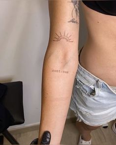 a woman with a tattoo on her arm that reads, cool sun and the word love