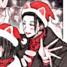 two people wearing christmas hats and giving the peace sign with their hands in front of them