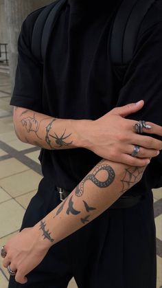 a man with tattoos on his arm and arms