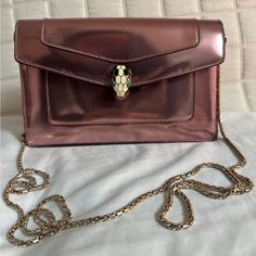 Never Used. Condition Exactly As Pictures Show. Chain Is Removable. Height: 5.5" Depth: 2" Width: 8" Shoulder Strap Drop: 23" Elegant Metallic Bag With Chain Strap, Elegant Metallic Bag As Gift, Elegant Metallic Bag For Gift, Elegant Metallic Bags For Gifts, Elegant Silver Bag With Chain, Elegant Silver Bags With Chain Detail, Elegant Metallic Bag With Chain, Elegant Metallic Bags With Chain, As Pictures