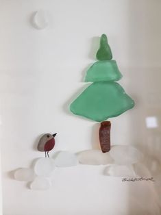 there is a glass decoration with a bird on the top and a tree on the bottom