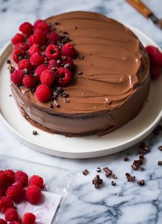 a cake with chocolate frosting and raspberries on top