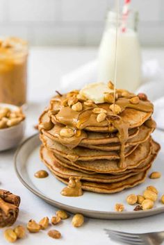 a stack of pancakes topped with peanut butter and syrup