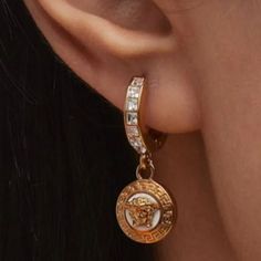 Versace Drop Hoop Earrings Feature Signature Medusa Emblem Surrounded By Engraved Greca Motif Gold-Tone Brass And Enamel Channel-Set Glass Rhinestones For Pierced Ears Made In Italy( Be Aware Of Cheap Fakes, Look For Auotentic Logo). About Versace: Founded In 1978 By The Late Gianni Versace, This Italian Design House Specializes In Sizzling Glamour. Gianni’s Sister, Donatella Versace, Has Designed The Label Since 1997, Creating Luxuriously Sexy Dresses And Separates. The Line Also Includes Shoes Versace Medusa Stud Earrings, Drop Hoop Earrings, Versace Jewelry, Donatella Versace, Channel Set, Gianni Versace, Design House, Pierced Ears, Italian Design