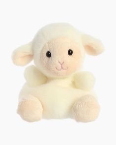 a white stuffed sheep sitting up against a white background