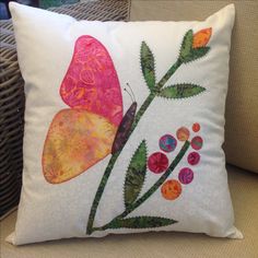 a decorative pillow with a butterfly on it