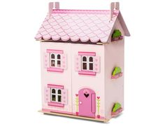 a pink doll house with a star above it