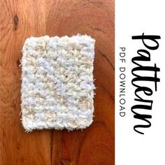 a white crocheted dishcloth sitting on top of a wooden table next to a wood floor