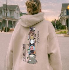 a person wearing a hoodie with spirited dolls on it