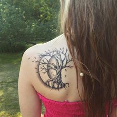 a woman with a tree tattoo on her back