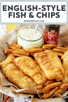 fish and chips are served in a basket with ranch dressing on the side for dipping