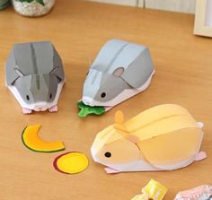 three paper mice sitting on top of a wooden table