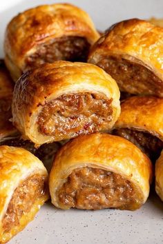 some sausage rolls are on a plate and ready to be eaten