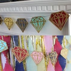 several different colored diamond shaped decorations hanging from a mantle