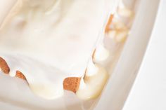 a piece of cake sitting on top of a white plate covered in frosted icing