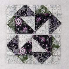 two quilted squares with purple flowers on them