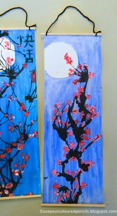 two paintings are hanging on the wall next to each other, one is decorated with red flowers