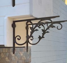 the corner of a building with a clock on it's side and wrought iron railing