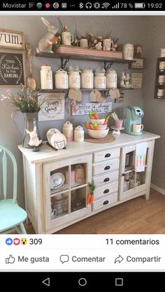 an image of a room that is decorated in white and has many items on the shelves