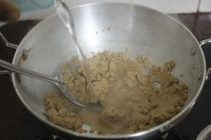 a silver pan filled with food on top of a stove next to a burner