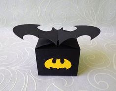 an origami box with a batman symbol on the front and bat logo on the back