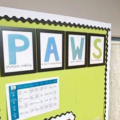 a green bulletin board with black and white pictures on it's sides, labeled paws