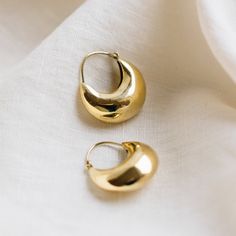 The Soneeya Crescent Teardrop Hoop Earrings are the definition of subtle elegance. Handcrafted by talented artisans from the Association for Craft Producers in Nepal, these earrings are a testament to tradition, skill, and beauty. Each earring boasts a unique design, featuring a puffed crescent shape that hangs horizontally, exuding a timeless allure. The inner curve of the crescent is left open, creating a captivating interplay of light and shadow, while the outer edges shimmer with understated Teardrop Hoop Earrings, Bath And Body Shop, Crescent Shape, Fall Essentials, Accessories Bags Purses, Dream Jewelry, Animal Jewelry, The Body Shop, Jewelry Bags