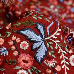 the red floral fabric has blue, pink and white flowers on it's side