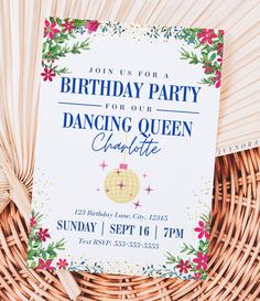 a birthday party card sitting on top of a table next to a wicker basket