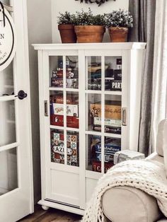 a white bookcase with many books in it