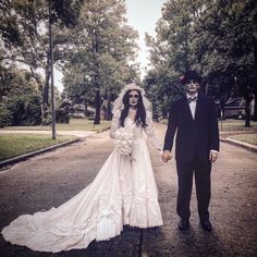 a bride and groom walking down the street in their wedding day attire with skeleton makeup