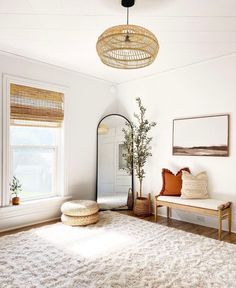 a living room with white walls and rugs