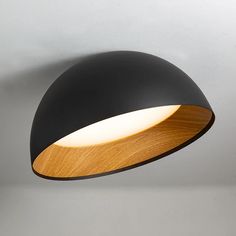 a black and wooden light hanging from the ceiling