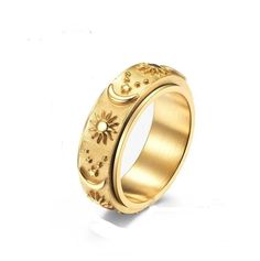 a yellow gold ring with flowers and stars on the outside, set against a white background