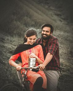 a man and woman sitting on a bike together