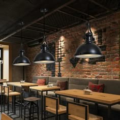 a restaurant with brick walls and wooden tables, stools and lights hanging from the ceiling