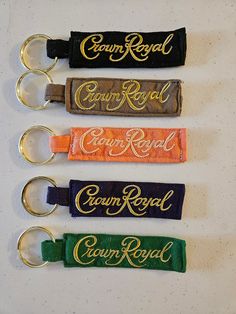 four key chains with the words crown royal on them