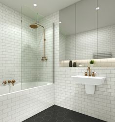 a white tiled bathroom with two sinks and a bathtub