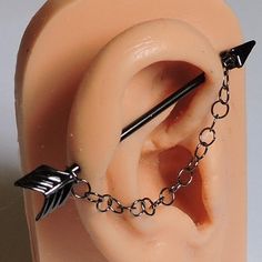 a fake ear with an arrow attached to it's side and chain around the ear