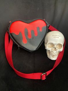 I just finished making this Bleeding Heart Bag. I love the contrasting red vinyl drip. The rest of the bag is made with black vinyl, and lining is made with a red water proof canvas.  I made a red adjustable strap, with gunmetal black hardware (lobster clasps, d rings, and adjustable buckle). You can see the main zipper pull is a gunmetal black heart shaped rib cage.  I have added a slip pocket and a zipper pocket to this small bag. I love having pockets and options to put my things in.  Dimensions/Details:  1) 9 inches at the widest part of the heart.  2) 3 inches deep  3) 8 inches at its tallest point.  4) gunmetal black, d rings, lobster clasps,  5) black vinyl, and red vinyl 6) adjustable and removable crossbody strap extends to 45 inches  Pattern Credit: K.Azcona Designs Red Shoulder Bag For School On Valentine's Day, Red Shoulder Bag With Adjustable Strap For Valentine's Day, Red Leather Shoulder Bag For Valentine's Day, Valentine's Day Red Leather Shoulder Bag, Valentine's Day Red Shoulder Bag With Adjustable Strap, Black Leather Heart-shaped Bag, Red School Bag For Valentine's Day, Red Bag For School And Valentine's Day, Goth Bags