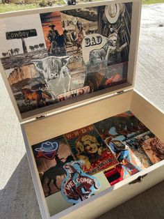 an open box with pictures and stickers on it